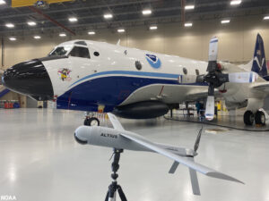 Above:  The Altius-600 uncrewed aircraft system demonstration model appears with Hurricane Hunter NOAA WP-3D Orion, known as “Miss Piggy,” at NOAA’s Aircraft Operations Center in Lakeland, Florida, during an uncrewed aircraft system flight test on May 25, 2022. The Altius was recognized by the 2024 Guinness World Records book for the longest endurance flight inside a tropical cyclone by an uncrewed aircraft. (Image credit: NOAA/Aircraft Operations Center)